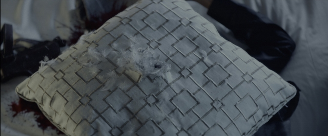 Wide shot frame from John Wick — bed, couch, pillow