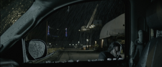 Wide shot frame from John Wick — sitting, street, mirror