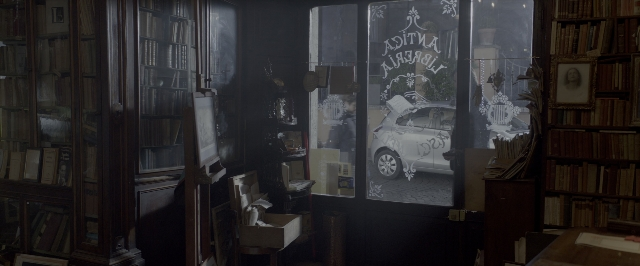 Wide shot frame from John Wick: Chapter Two — room, street, car