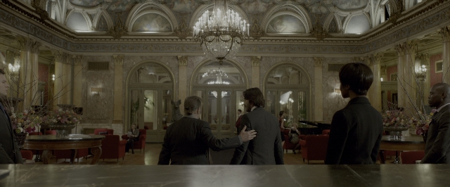 Medium shot frame from John Wick: Chapter Two — sitting, standing, room