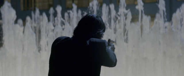Wide shot frame from John Wick: Chapter Two — standing, water, hair