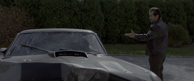 Wide shot frame from John Wick: Chapter Two — standing, car, hand