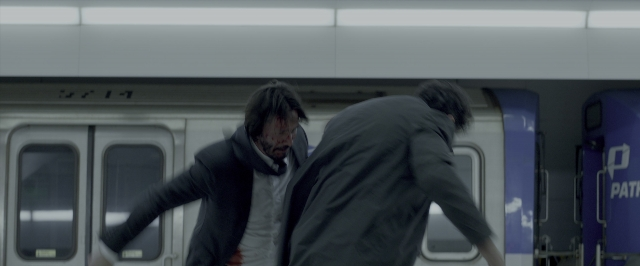 Frame from John Wick: Chapter Two — walking, beard, bag