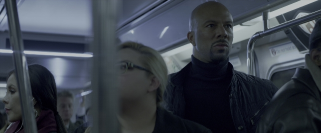 Wide shot frame from John Wick: Chapter Two — face, train, person