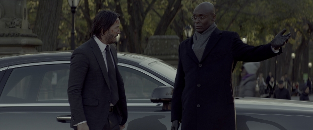 Wide shot frame from John Wick: Chapter Two — standing, walking, street