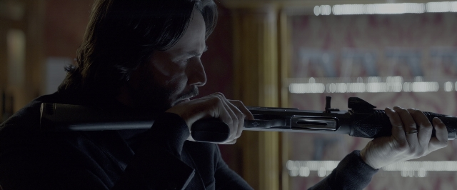 Frame from John Wick: Chapter Two — room, coat, hand