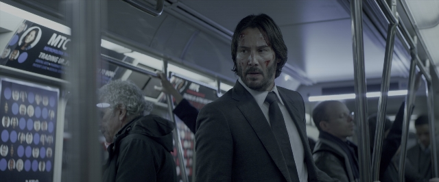 Wide shot frame from John Wick: Chapter Two — standing, suit, tie