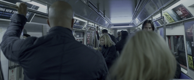 Wide shot frame from John Wick: Chapter Two — sitting, standing, car