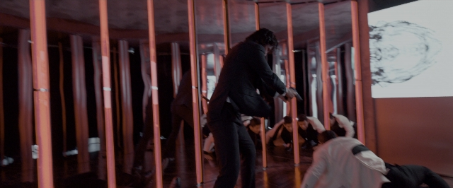 Wide shot frame from John Wick: Chapter Two — sitting, standing, room