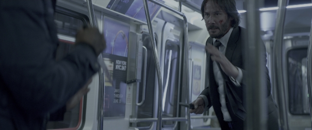 Wide shot frame from John Wick: Chapter Two — standing, hand, suit