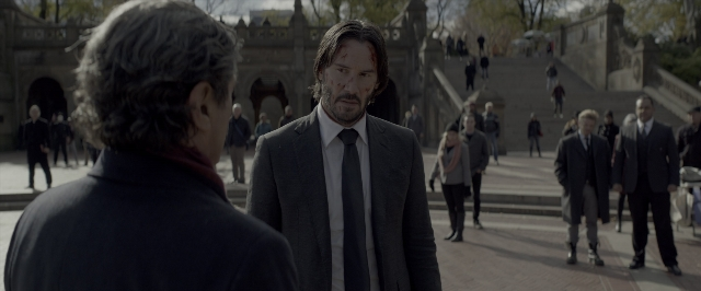 Medium shot frame from John Wick: Chapter Two — standing, suit, tie