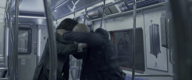 Wide shot frame from John Wick: Chapter Two — standing, hug, train