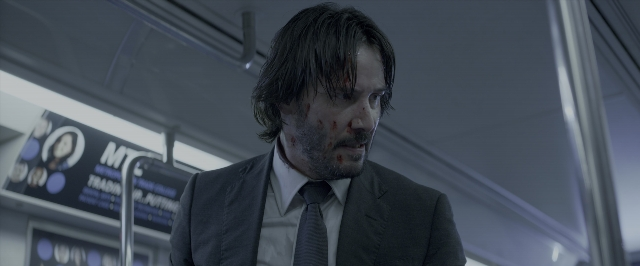 Wide shot frame from John Wick: Chapter Two — standing, suit, tie