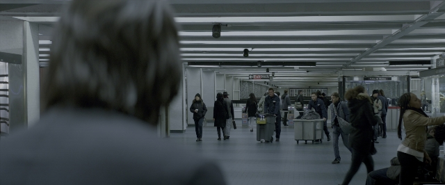 Wide shot frame from John Wick: Chapter Two — walking, glass, train