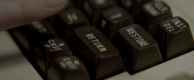Wide shot frame from John Wick: Chapter Two — person, computer keyboard