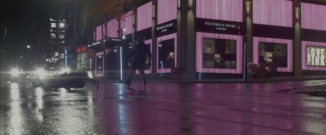 Wide shot frame from John Wick: Chapter Two — walking, street, car