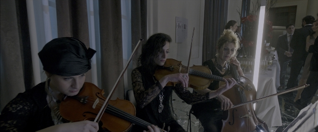 Medium shot frame from John Wick: Chapter Two — room, hat, dress