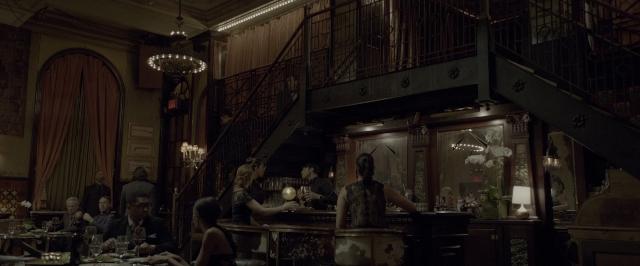 Wide shot frame from John Wick: Chapter Two — sitting, standing, room