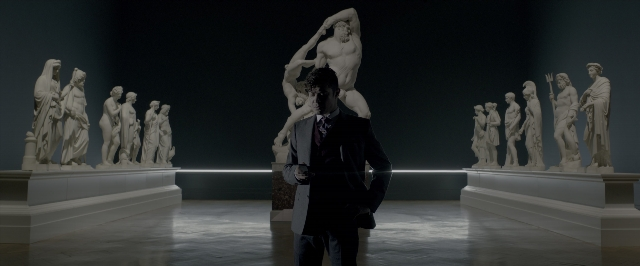 Wide shot frame from John Wick: Chapter Two — standing, room, suit