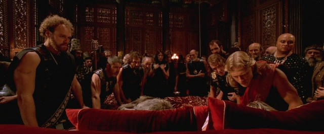 Wide shot frame from Alexander — standing, room, bed