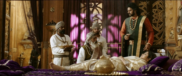 Wide shot frame from Bãhubali 2: The Conclusion — standing, room, bed