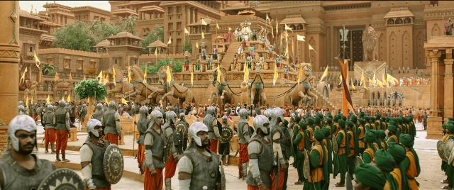 Wide shot frame from Bãhubali 2: The Conclusion — sitting, standing, hat