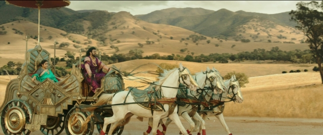 Wide shot frame from Bãhubali 2: The Conclusion — sitting, horse, cart