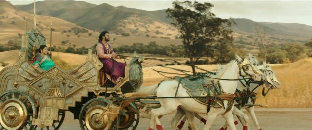 Wide shot frame from Bãhubali 2: The Conclusion — sitting, street, dress
