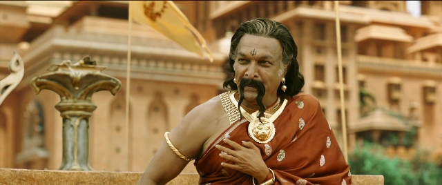 Wide shot frame from Bãhubali 2: The Conclusion — standing, mustache, face