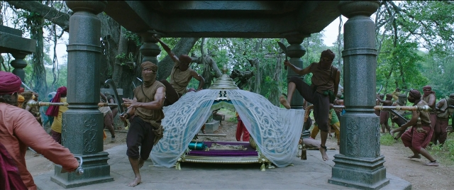 Medium shot frame from Bãhubali 2: The Conclusion — standing, bed, person