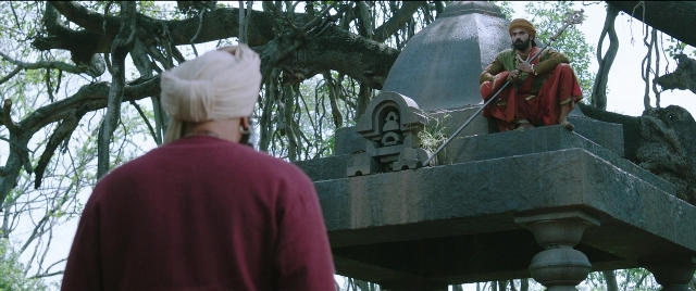 Wide shot frame from Bãhubali 2: The Conclusion — sitting, standing, dialogue