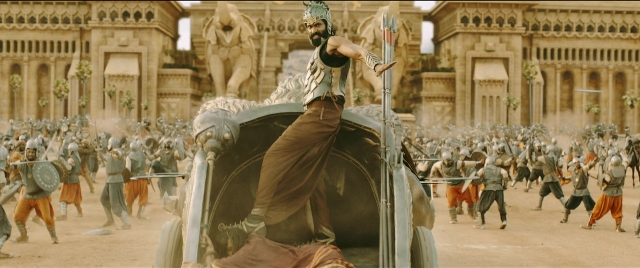 Wide shot frame from Bãhubali 2: The Conclusion — sitting, hat, horse