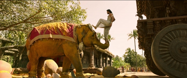 Wide shot frame from Bãhubali 2: The Conclusion — sitting, elephant, person