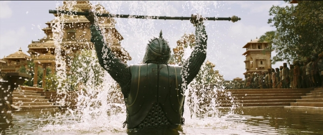 Wide shot frame from Bãhubali 2: The Conclusion — standing, hat, water