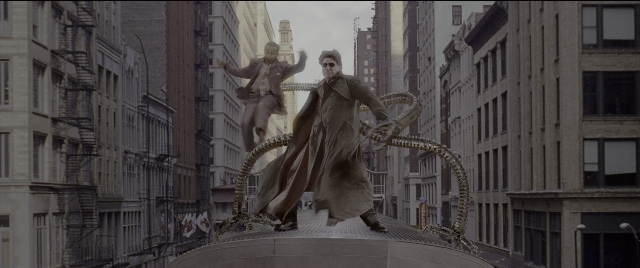 Wide shot frame from Spider-Man 2 — standing, hat, coat