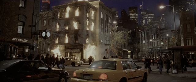 Wide shot frame from Spider-Man 2 — walking, street, fire