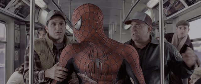 Wide shot frame from Spider-Man 2 — standing, hat, suit