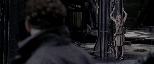 Wide shot frame from Spider-Man 2 — standing, room, dress