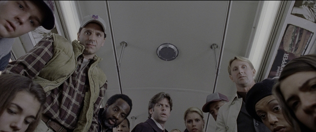 Wide shot frame from Spider-Man 2 — standing, hat, suit