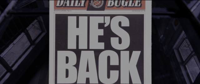Wide shot frame from Spider-Man 2 — street, newspaper, lamp