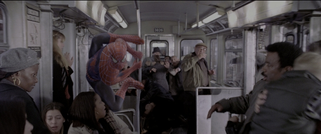 Wide shot frame from Spider-Man 2 — hat, car, suit