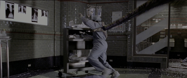 Wide shot frame from Spider-Man 2 — room, coat, face