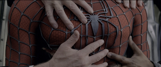 Wide shot frame from Spider-Man 2 — suit, person, human hand