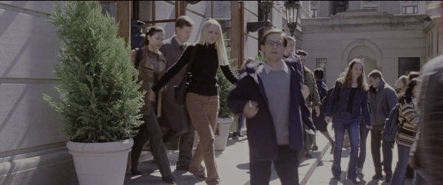 Wide shot frame from Spider-Man 2 — walking, street, coat