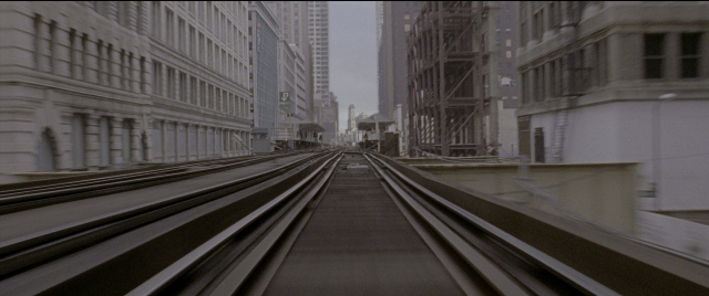 Wide shot frame from Spider-Man 2 — train, building
