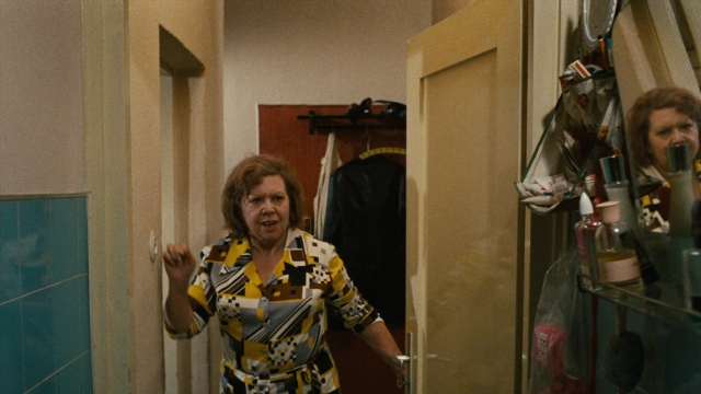 Wide shot frame from Angst essen Seele auf — standing, door, hand