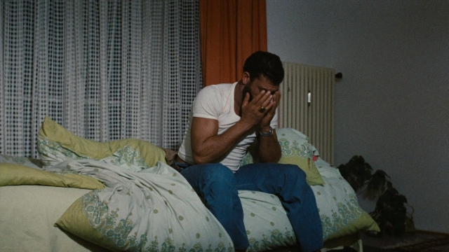 Wide shot frame from Angst essen Seele auf — sitting, room, bed