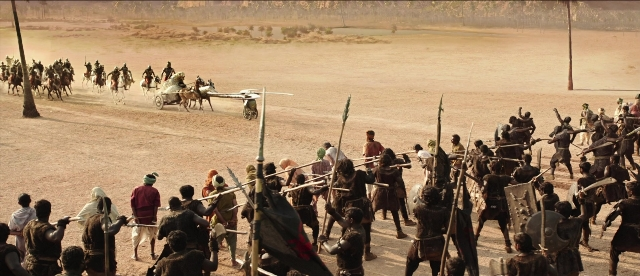 Wide shot frame from Bãhubali: The Beginning — horse, train, person