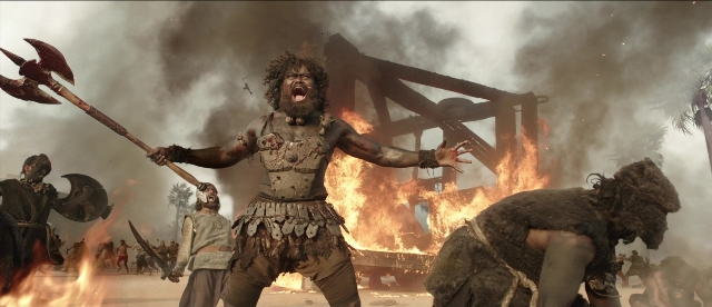 Wide shot frame from Bãhubali: The Beginning — fire, hand, beard