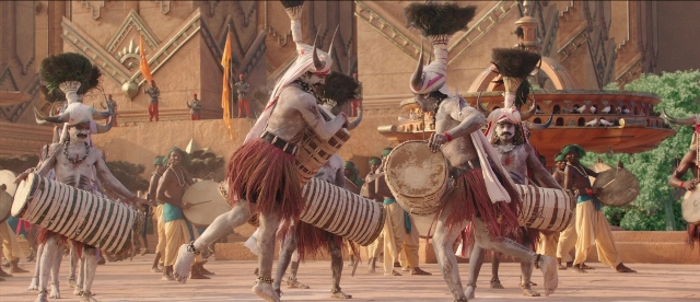 Wide shot frame from Bãhubali: The Beginning — standing, drum, person